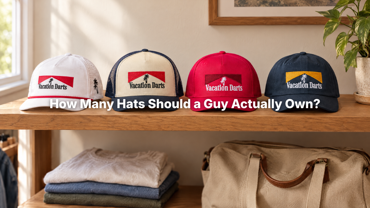 Four Vacation Darts hats lined up on a closet shelf